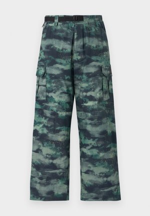 Cargo pants in a camouflage pattern featuring dark green, teal, and black shades. Wide leg design with side pockets and a belted waist.