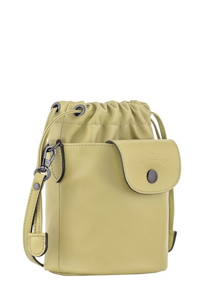 Green leather drawstring bag with a front flap pocket and metal accents. Features a smooth texture and adjustable strap.