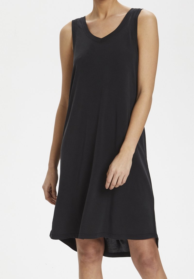 Černé bezramínkové šaty s V-výstřihem, volným střihem a mírně zaobleným lemem. Vyrobeny z měkké, lehké látky.