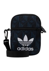 Black and blue nylon crossbody bag with a zippered front pocket, featuring a geometric pattern and white Adidas logo. Includes adjustable strap.