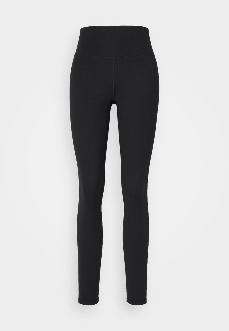 Legging noirs avec une taille haute, fabriqués en tissu extensible. Texture lisse, jambes fuselées et sans coutures ni motifs visibles.