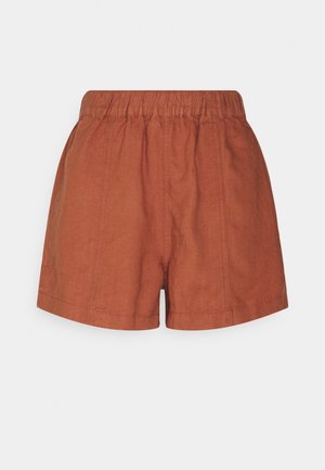 Shorts taille haute couleur rouille avec une taille élastique et des coutures verticales visibles à l'avant.
