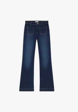 Dark blue flared jeans made of denim. Features five pockets, a zip fly, and gold stitching accents on seams. Wide leg opening.