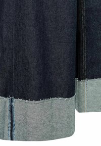 Tissu en denim avec une section principale bleu foncé, un ourlet bleu clair, des bords effilochés et des coutures contrastées le long des seams.