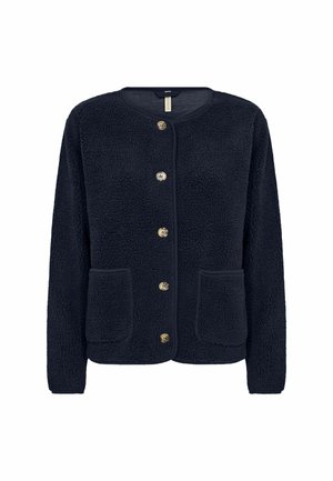 Tumesinine, pehme fliiskardigan pikkade varrukatega, ümar kaelus, kuldse tooniga nööbid ja kaks eesmist taskut. Omab tekstuuriga kangast.