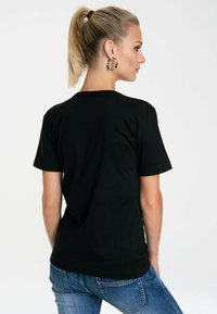 Black cotton t-shirt with a classic crew neck and short sleeves, shown from the back. The fabric appears soft with a smooth texture.