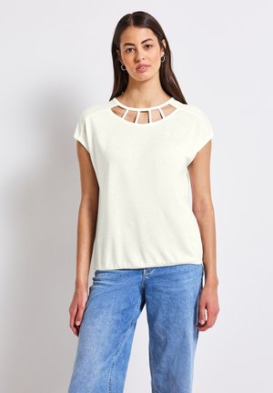 Jasny, krótki top z krótkim rękawem, z szerokim dekoltem i wycięciami. Miękka, teksturowana tkanina w luźnym kroju. Styl casual.