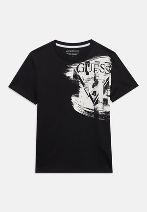 Juoda trumpomis rankovėmis marškinėliai su baltais abstrakčiais potėpiais ir GUESS logotipu, atspaustu viršutiniame dešiniajame priekiniame šone.