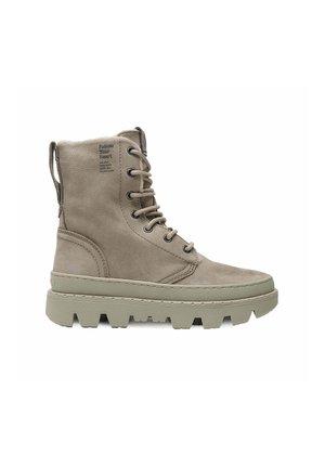 Light brown high-top leather boot with thick lug sole, lace-up front, pull tab at heel, and text "Follow Your Heart" near ankle.