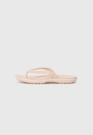 Light pink flip-flop sandals with a textured footbed, flexible straps, and a white sole accent. Flat design for casual wear.