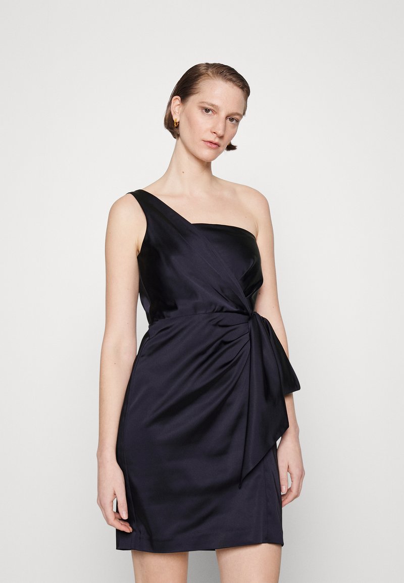 Asymmetric one-shoulder dress in dark navy satin, featuring a twisted waist detail and a smooth, streamlined silhouette.