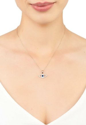 Silver necklace featuring an eye-shaped pendant with a blue center stone and decorative sparkling accents. Chain is slender and delicate.
