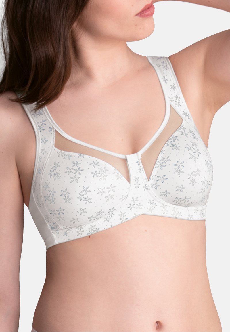 White bra with floral patterns in light blue, featuring sheer mesh panels at the upper cup, thick straps, and a stabilizing center gore.