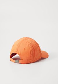 Orange baseball cap made of cotton with a curved brim, adjustable strap at the back, and visible stitching details.