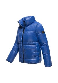 Blue puffer jacket with a high collar, front zip, two large pockets, quilted texture, and black logo patch on the sleeve.