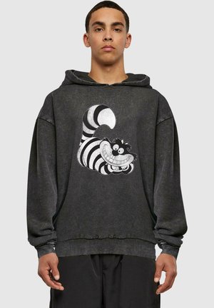 Black hoodie with a graphic of a grinning striped cat. Material has a textured finish, featuring a relaxed fit and ribbed cuffs.