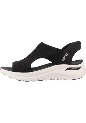 Sandalia negra de punto Skechers con suela gruesa blanca Arch Fit y correas abiertas en el dedo y el talón para mujer.