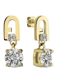 Des boucles d'oreilles dorées présentent un design géométrique avec un clou et des cristaux ronds transparents suspendus, mettant en valeur un mélange de textures et de brillance.