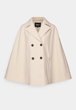 Beige wool blend cape coat with a double-breasted design, large lapels, and two side pockets; features dark buttons and a soft texture.