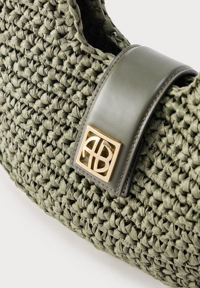 Olive green woven handbag with smooth leather strap and gold-tone square logo emblem on front flap.