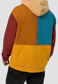 Felpa con cappuccio a blocchi di colore con pannelli arancioni, turchesi, marrone e gialli. Realizzata in materiale morbido, con vestibilità comoda e cappuccio con coulisse.