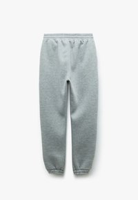 Lichtgrijze joggingbroek met een elastische tailleband en enkels, gemaakt van zachte stof met een gladde textuur en zonder zichtbare patronen.