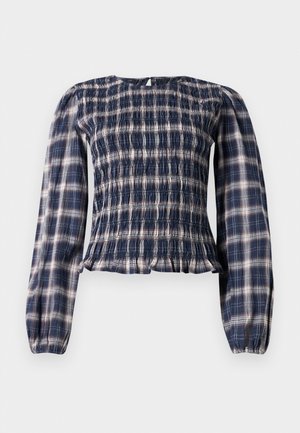 Navy blue plaid long-sleeve blouse with smocked bodice and gathered cuffs, featuring a small keyhole button closure at the back neckline.
