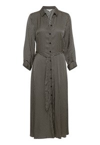 Svart och vit prickig skjortklänning med långa ärmar, krage, knappstängning och knytvidd i midjan. Tillverkad av ett mjukt tyg med lös passform.