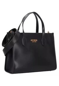 Sac à main en cuir noir avec deux poignées supérieures et une bandoulière amovible. Caractéristiques : lettrage de la marque en or et fermeture zippée.