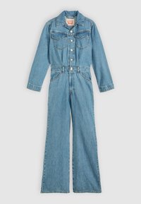 Φ ωτεινό γαλάζιο τζιν ολόσωμο με μακριά μανίκια, κουμπωτό μπροστά, δύο τσέπες στο στήθος και παντελόνι φαρδιάς γραμμής. Διαθέτει διακοσμητικές ραφές και κλασικό γιακά.