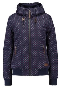 Veste à capuche bleu marine avec des pois roses et blancs, fermeture éclair à l'avant, capuche avec cordon, poches latérales zippées et poignets et ourlet côtelés.