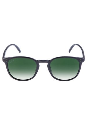Zwarte plastic zonnebril met groene gradient lenzen. Rond model met dunne, gebogen pootjes met lichte inkepingen nabij de slapen.