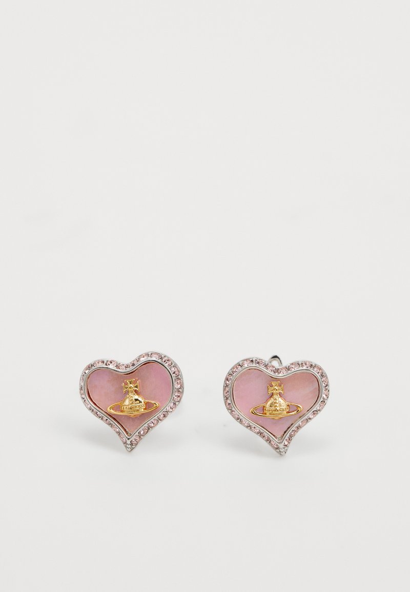 Heart-shaped stud earrings with pink stone centers, gold planet-shaped emblem, and small clear crystals around the edges on white background.