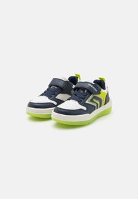 Blue and white sneakers with a rubber sole. Features lime green accents, a Velcro strap, and mesh panels for breathability.