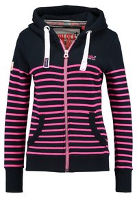 Felpa a strisce blu e rosa con zip frontale, due tasche e cappuccio con cordoncino. I polsini e l'orlo a costine migliorano la vestibilità e il comfort.