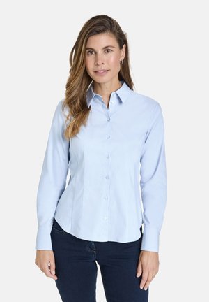 Light blue button-up shirt with a collar, long sleeves, and a tailored fit. Made of smooth fabric, featuring subtle sheen and no patterns.
