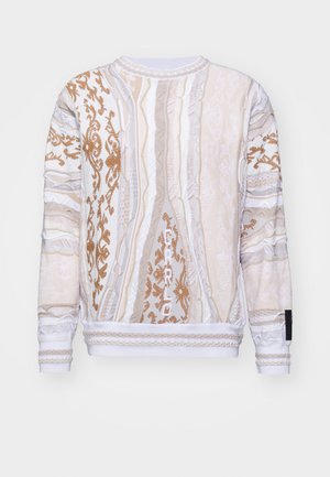 Sweatshirt dans des teintes crème et beige avec des motifs texturés complexes. Présente un col rond, des poignets et un ourlet côtelés, avec un détail d'étiquette tissée.