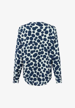Long-sleeve shirt featuring a navy blue and white polka dot pattern, rounded hem, and a relaxed fit with cuff details on sleeves.