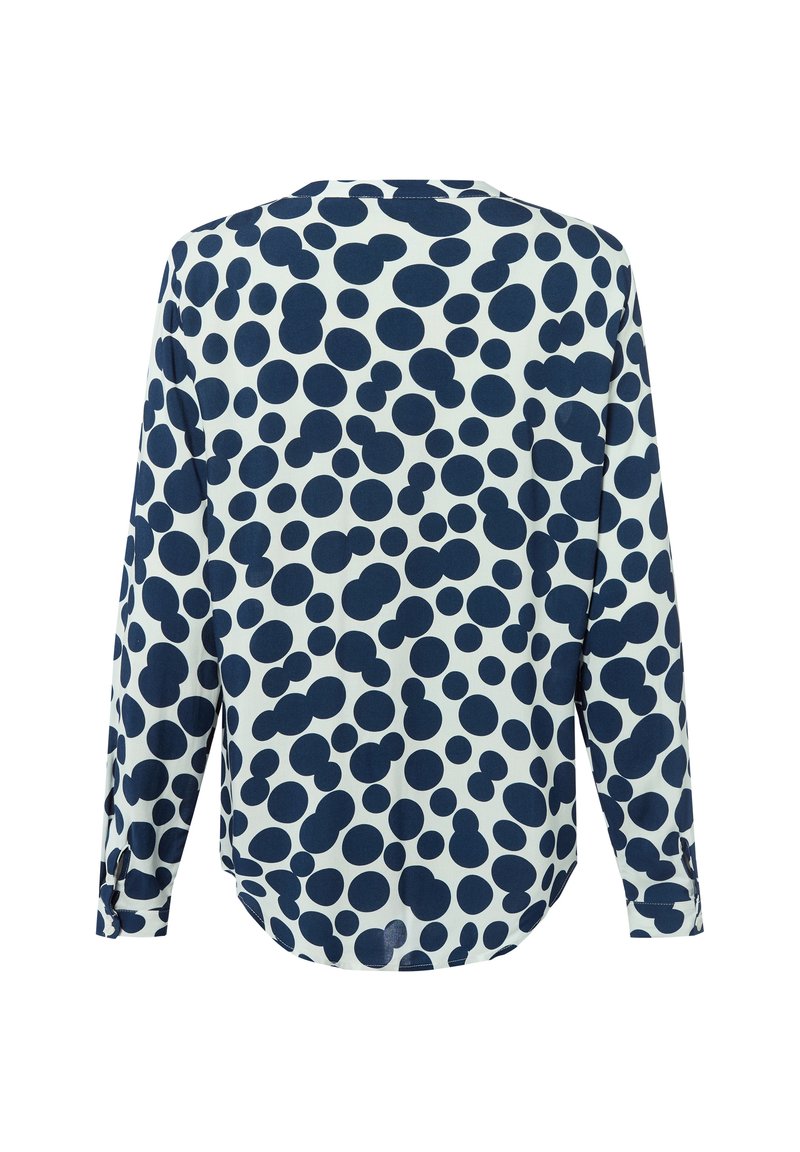 Camicia a maniche lunghe con motivo a pois blu navy e bianchi, orlo arrotondato e vestibilità rilassata con dettagli ai polsini delle maniche.