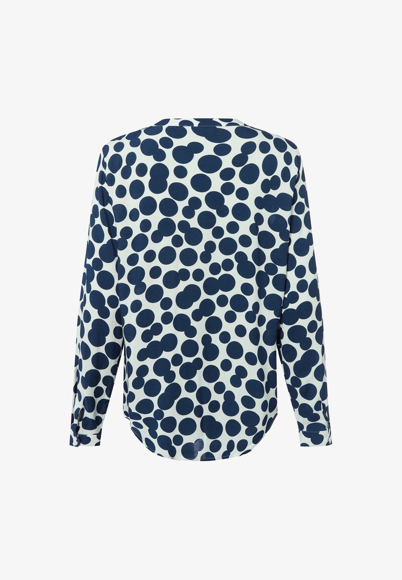 Camicia a maniche lunghe con motivo a pois blu navy e bianchi, orlo arrotondato e vestibilità rilassata con dettagli ai polsini delle maniche.