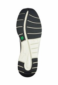 Schwarze Gummisohle mit weißen Akzenten, mit einer strukturierten Oberfläche, Rillen für Traktion und einem grünen dreieckigen Logo.