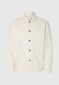 Μακρυμάνικο εκρού σακάκι με γιακά, καφέ κουμπιά κατά μήκος του μπροστινού μέρους και δύο μεγάλες μπροστινές τσέπες.