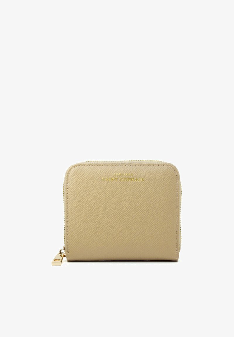 Beige textured leather wallet with gold-tone branding, zip closure, and minimalistic design. Key feature includes a small metallic zipper pull.
