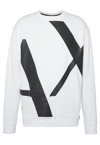 Bílé sweatshirty s velkými černými abstraktními tvary. Vyrobeno z měkké tkaniny s žebrovanými manžetami a kulatým výstřihem. Jednoduchý a moderní design.