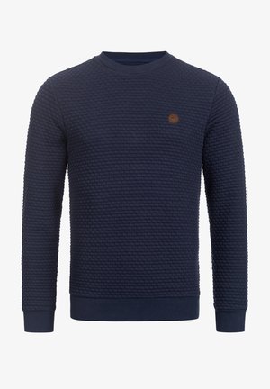 Marineblå sweatshirt med struktur, rund halsudskæring, ribstrikkede manchetter og kant. Har en lille brun logo-patch på brystet.