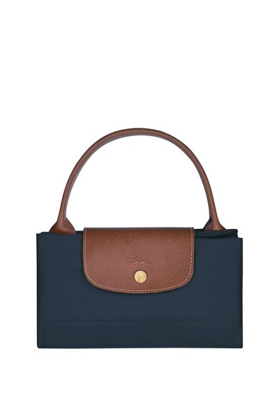 Navy blue fabric handbag with a brown textured leather flap, gold snap closure, and a brown leather handle. Smooth surface with soft edges.