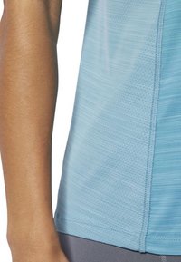 Light blue athletic shirt featuring a textured pattern, short sleeves, and flat seams, designed for comfort during physical activities.