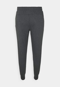 Mörkgrå avsmalnande sweatpants med elastiskt midjeband och muddar, visade bakifrån mot en vit bakgrund.