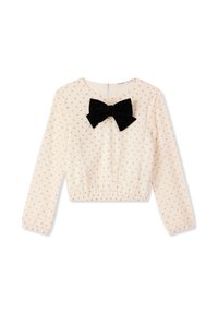 Top cropped in crema con maniche lunghe, caratterizzato da un fiocco in velluto nero e un piccolo motivo a cuori dorati, fondo elastico e chiusura con zip sul retro.