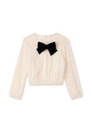 Top cropped in crema con maniche lunghe, caratterizzato da un fiocco in velluto nero e un piccolo motivo a cuori dorati, fondo elastico e chiusura con zip sul retro.